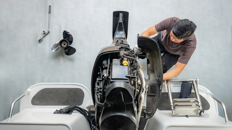 Mechanic working on a boat engine.