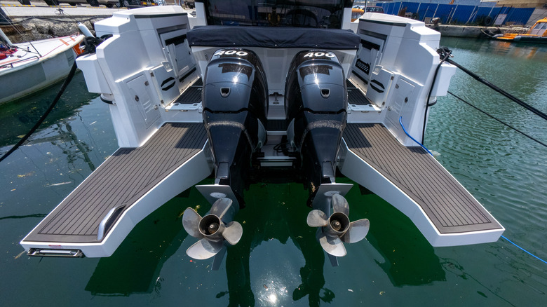 Two outboard boat engines out of the water.
