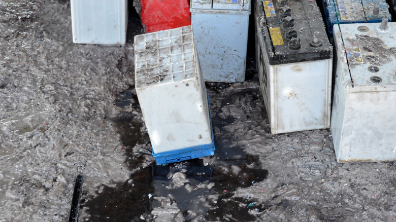 A collection of old and leaking car batteries