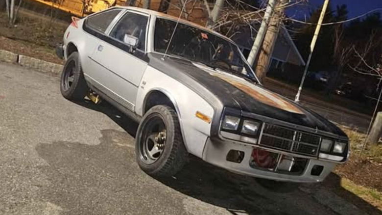 Silver, black, and rusted AMC Spirit