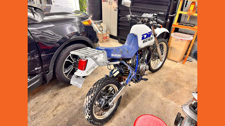Blue and white DR650S in a garage