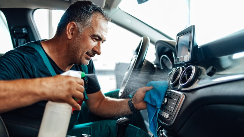 A personification utilizing spray cleaner and cloth to cleanable wrong of car