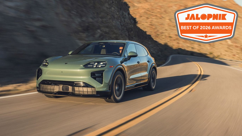 Green Porsche Cayenne Turbo Electric driving down a mountain road