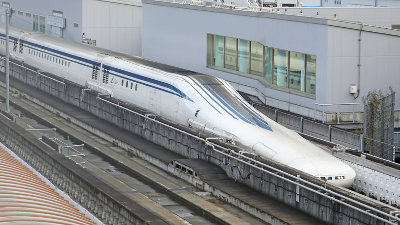 A Japanese Shinkansen parked at a train station