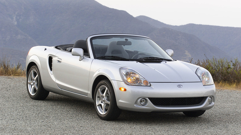 A silver 2003 Toyota MR2 Spyder parked near mountains