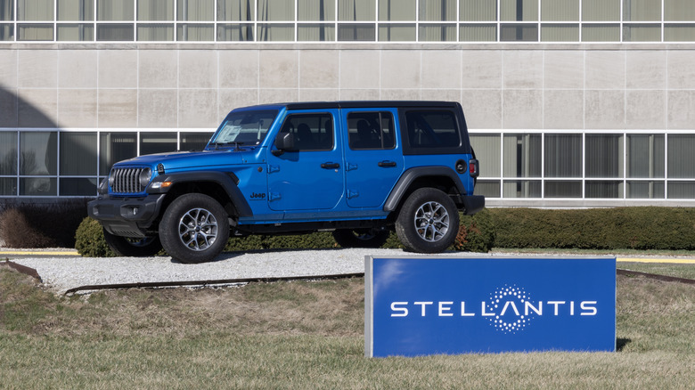 Jeep Wrangler next to a Stellantis sign.
