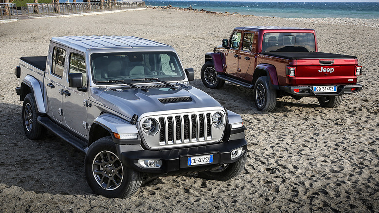 Two Jeep Gladiators parked on the beach
