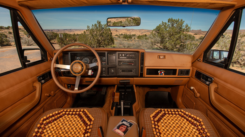 Interior view of the XJ Pioneer, complete with 80s touches like beaded seat covers and a Rubik's Cube on the dashboard