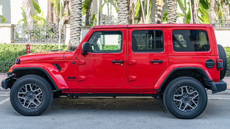 Side view of a red 2024 Jeep Wrangler 4-door