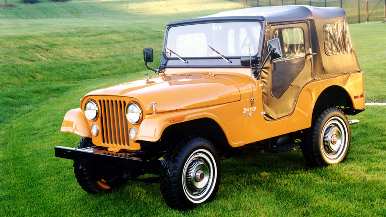 Orange 1973 Jeep CJ-5 front left view seen parked on grass