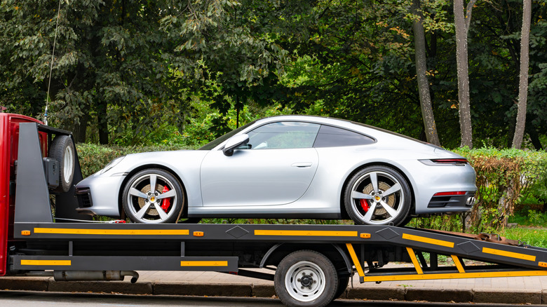 A porsche being transported in moscow