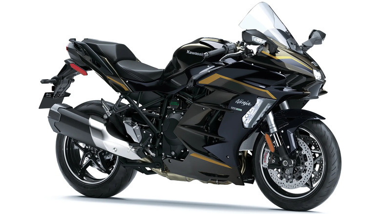 A black and gold Kawasaki Ninja H2 SX hyper-touring motorcycle shown in a studio side-three-quarter profile on a white background.
