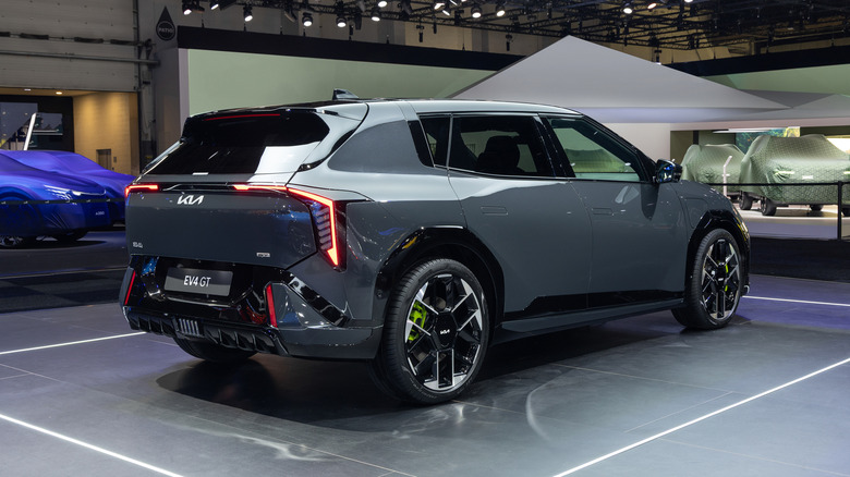 Rear 3/4 view of a grey Kia EV4 GT hatchback