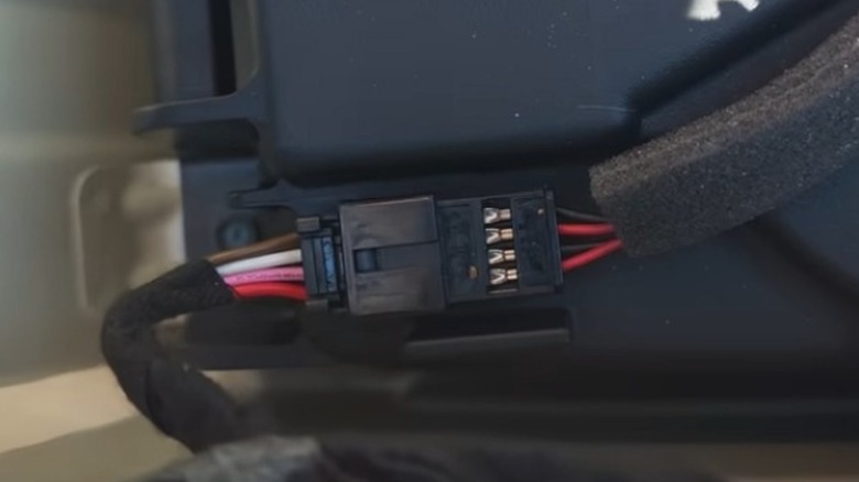 An image capture from Technically Jeff's video showing the corrected wiring, on the on the right, for the Meridian subwoofer.