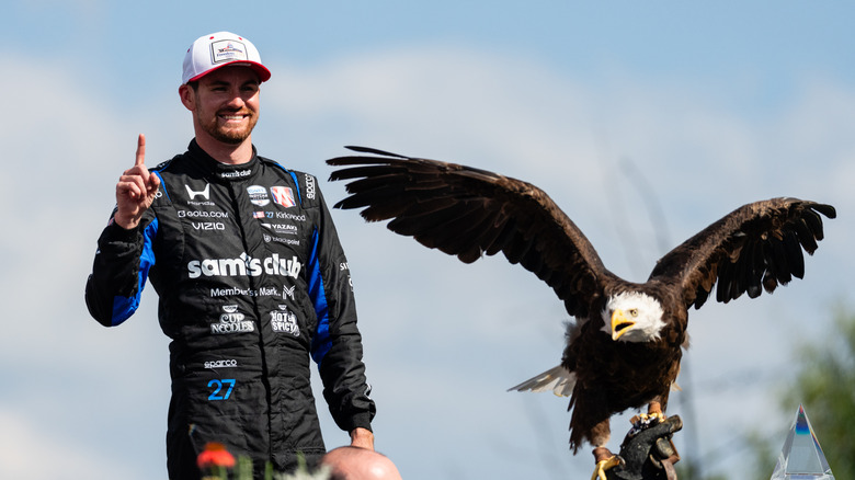 Race winner Kyle Kirkwood, driver of the #27 Sam's Club Andretti Global Honda, poses with an bald eagle after the NTT INDYCAR Series on August 23, 2026 in Washington, DC.