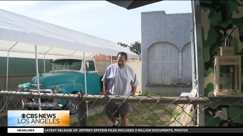 A man walks in front of a beautiful old Chevy pickup