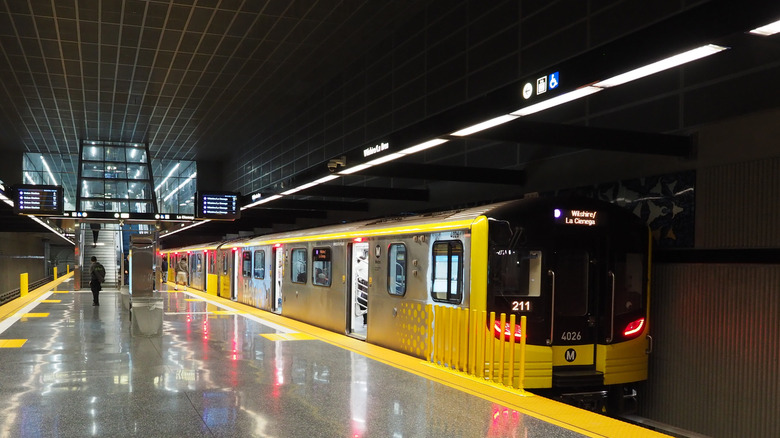 A photo from inside an LA underground metro station at Wilshire and La Cienega with a train visible and one person