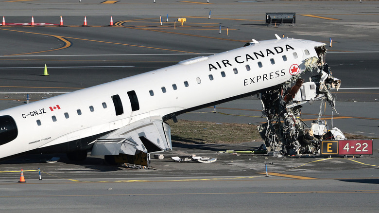 An Air Canada Express CRJ-900 sits on the runway after colliding with a Port Authority fire truck at LaGuardia Airport on March 24, 2026 in New York City.