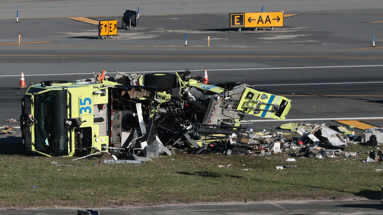 A destroyed Port Authority fire truck sits on a runway after colliding with an Air Canada Express CRJ-900 at LaGuardia Airport on March 24, 2026 in New York City.