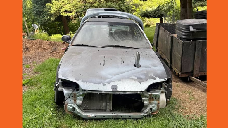 A clapped out Honda Civic looking dilapidated