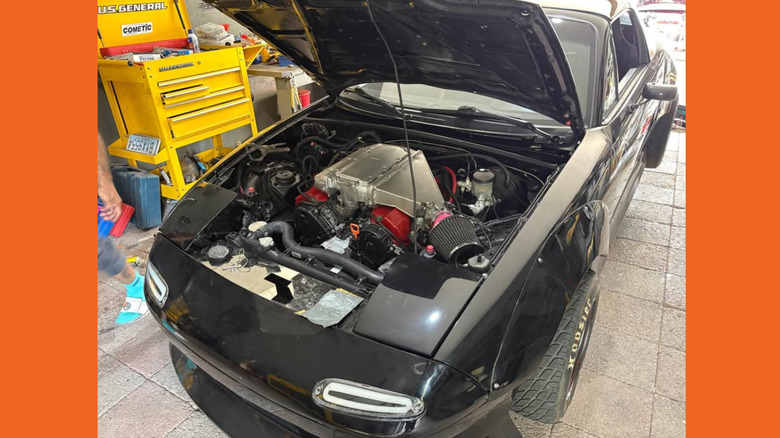 Engine bay of an NA Miata, showing Honda V6 engine