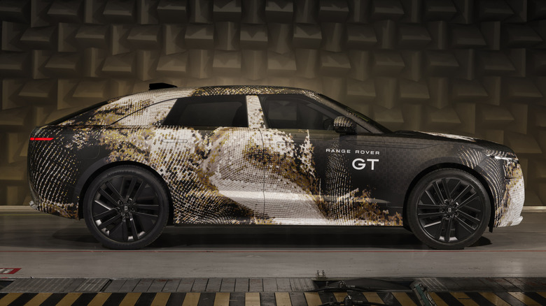 Side view of a camouflaged Range Rover GT