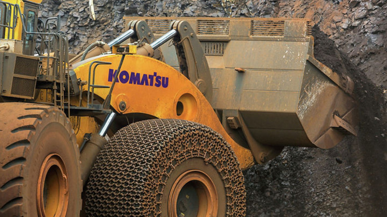 The Komatsu WE2350 wheel loader at the work site  wearing Firestone 70/70-57 tires .
