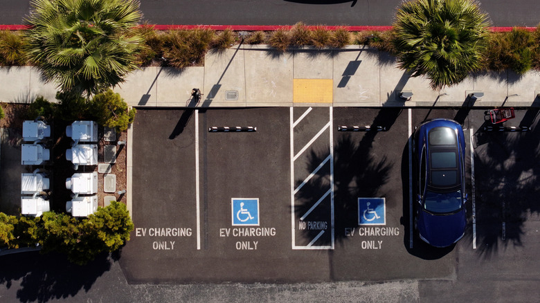 In an aerial view, electric vehicles sit parked at a Tesla charging station on June 12, 2025 in Sausalito, California.