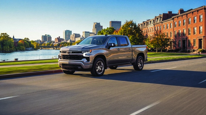 Front 3/4 of 2026 Chevrolet Silverado on road in sharp sunlight