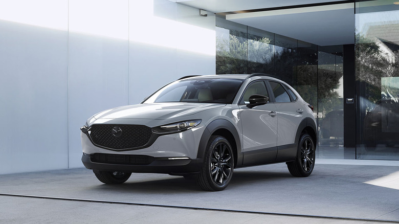 Front 3/4 2026 Mazda CX-30 parked near modern architecture