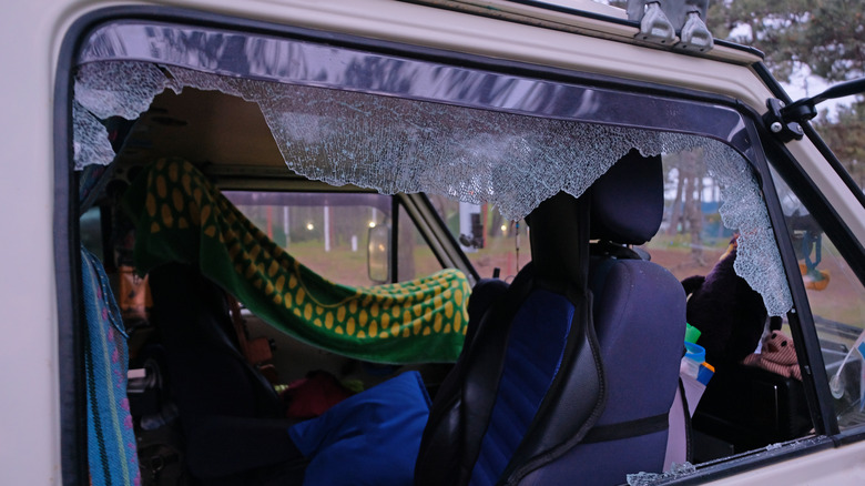 Close-up of a broken passenger window on a camper van