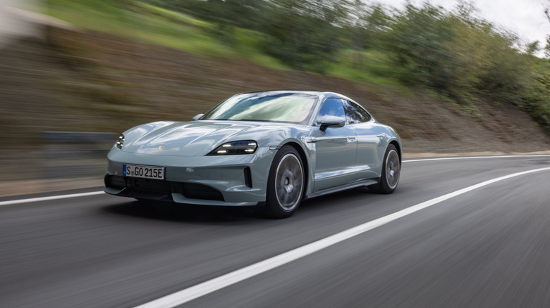 A Porsche Taycan driving past the scenery quickly