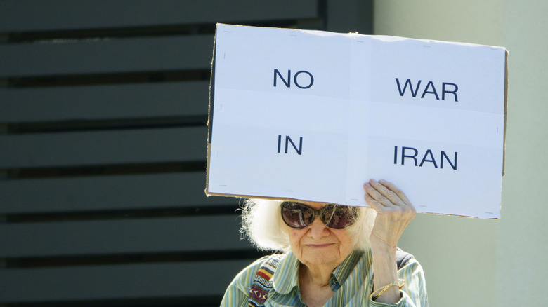 An elderly protester holds up a 