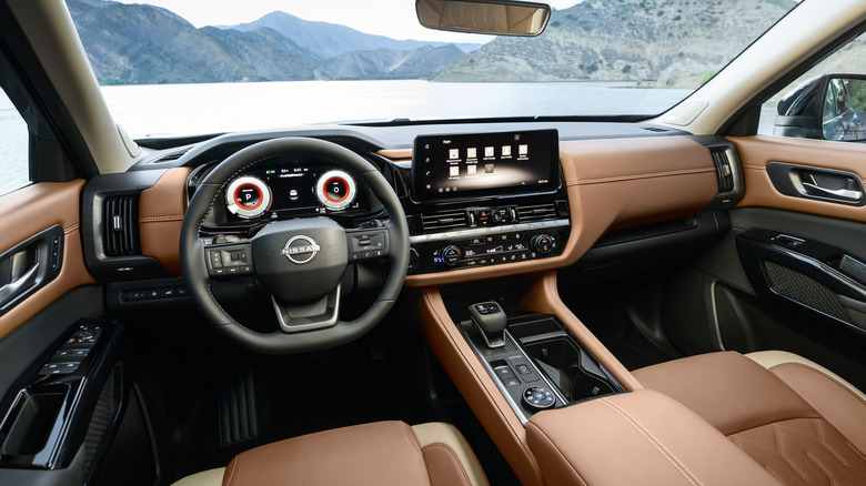 Driver's POV in the new Pathfinder showing the brown leather interior and a view of a lake out the windshield