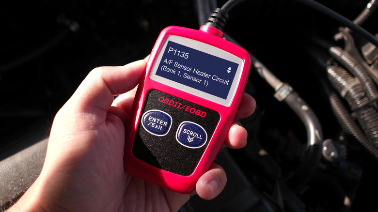 Mechanic holding OBD-II scanner