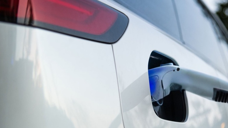A white EV being charged