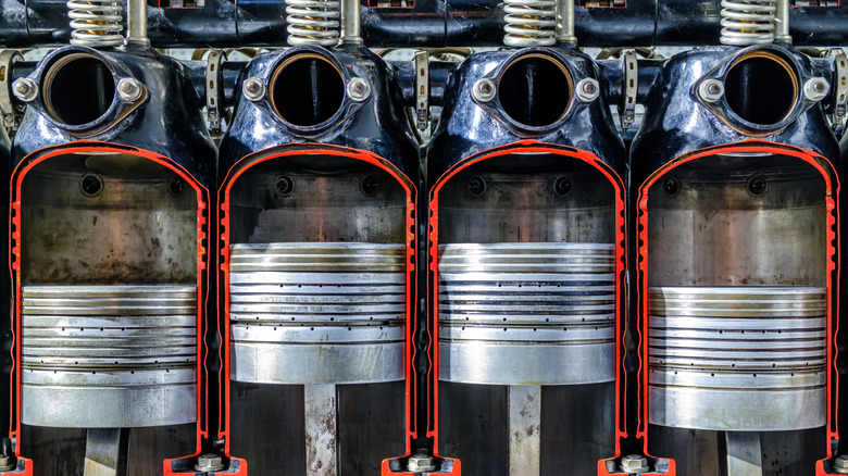 Close-up view of pistons and cylinders in an engine at a mechanic workshop