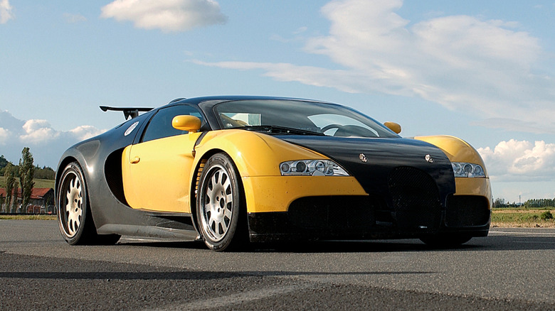 Front 3/4 view of a yellow and black Bugatti Veyron prototype