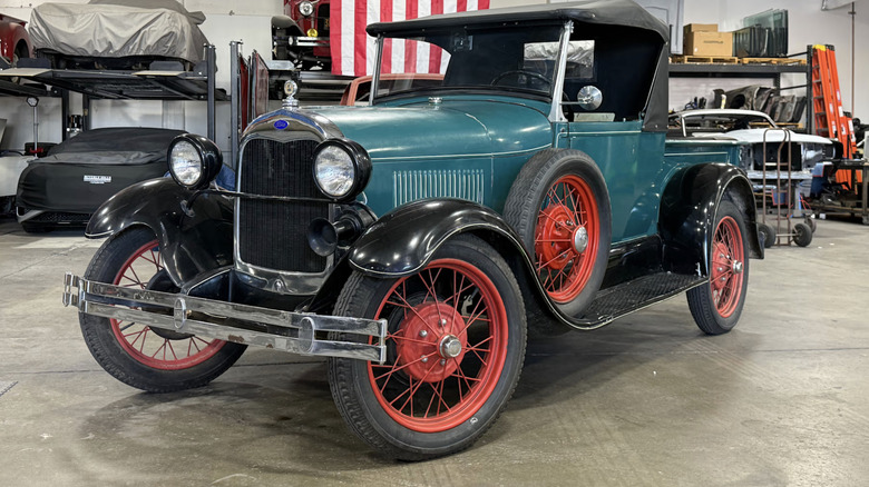 Green 1928 Ford Model A Roadster Pickup with red wheels