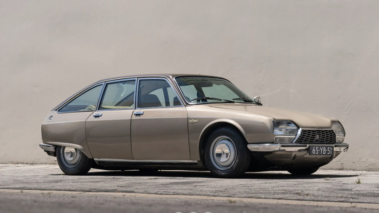 clay colored 1973 Citroën GS Birotor parked in front of a wall a similar shade of brown-gray