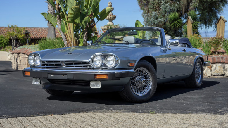 Silver 1990 Jaguar XJS Convertible parked in a california parking lot on a cloudless day