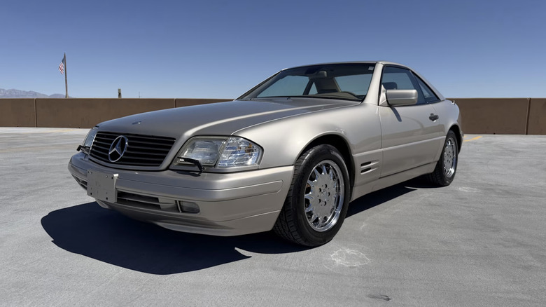 a silver 1998 Mercedes-Benz SL500 parked on a roof top