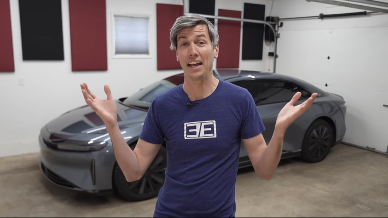 Jason Fenske of Engineering Explained standing in front of his Lucid Air that Lucid bought back