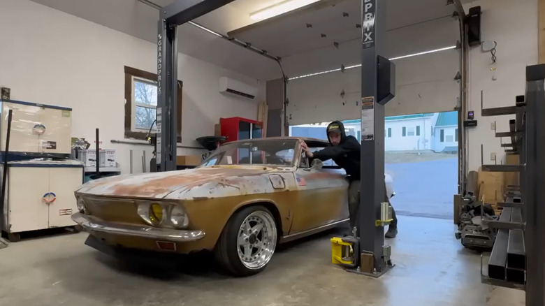 Ludwick pushing an airbagged Corvair into Ludwick's Garage
