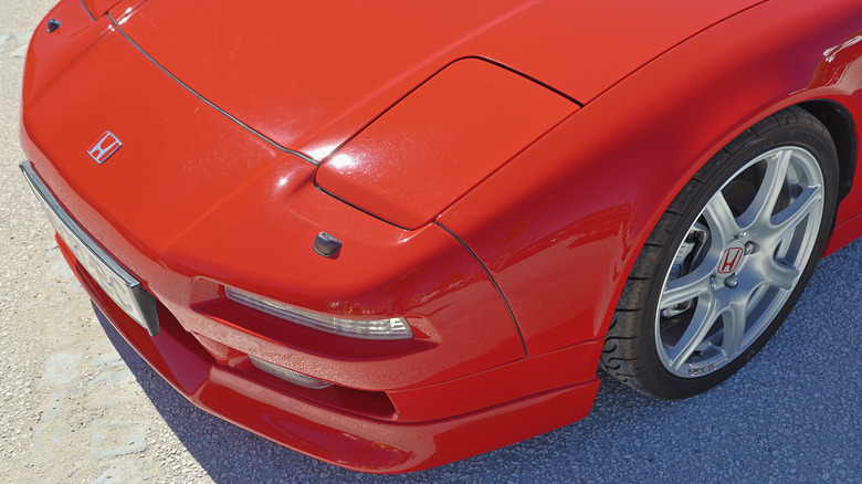 The hidden headlights of a first-gen Acura NSX parked outside