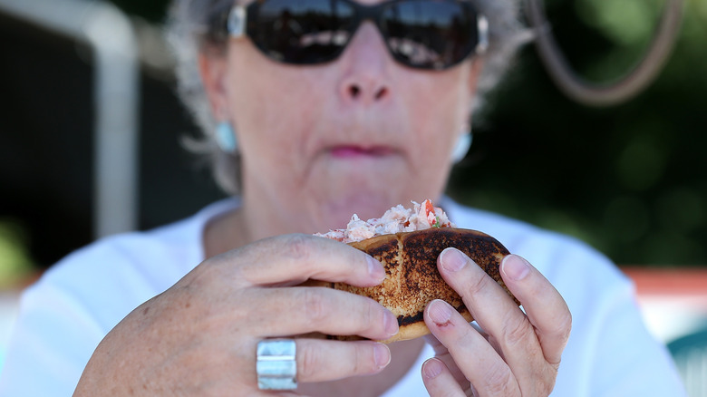 woman eating a lobster roll
