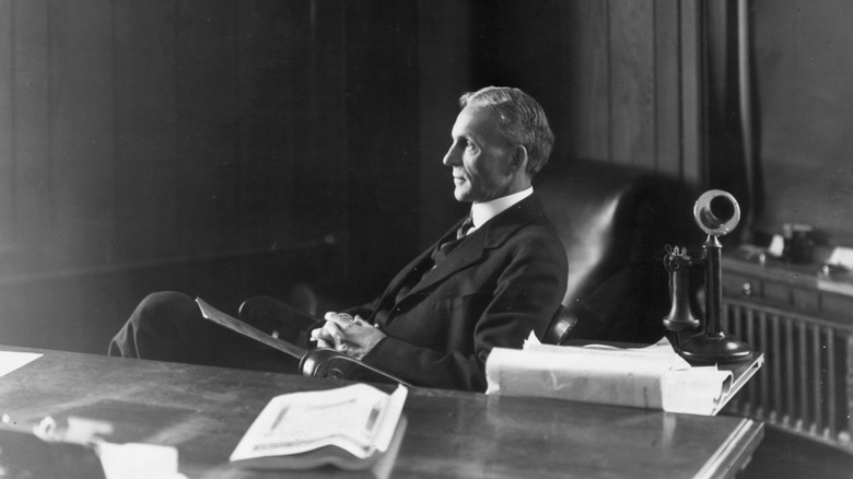 Henry Ford sitting at his desk