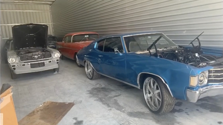 Classic cars stashed inside a storage unit while being recovered by police