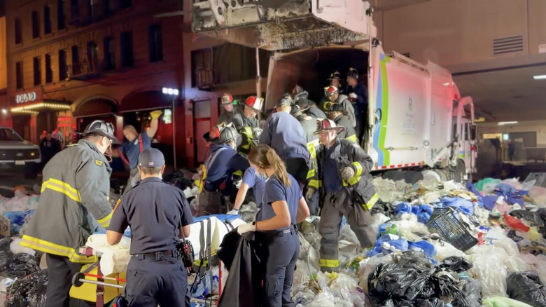 San Francisco Fire Department members freeing a man trapped in a garbage truck