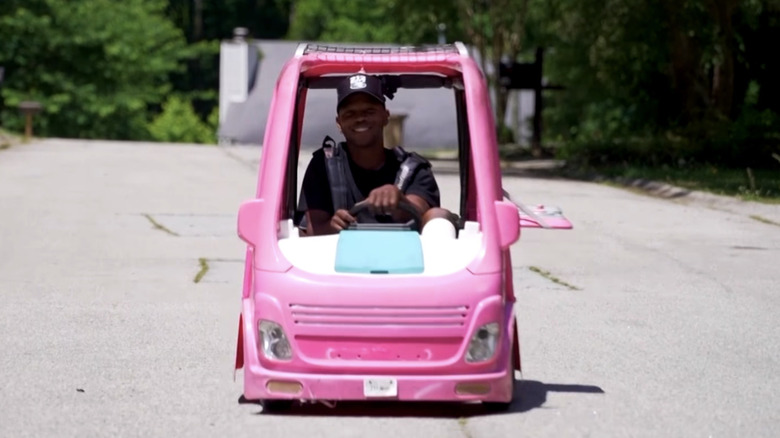 Front view of Mali Hightower driving his highly modified Power Wheels Barbie Dream Camper
